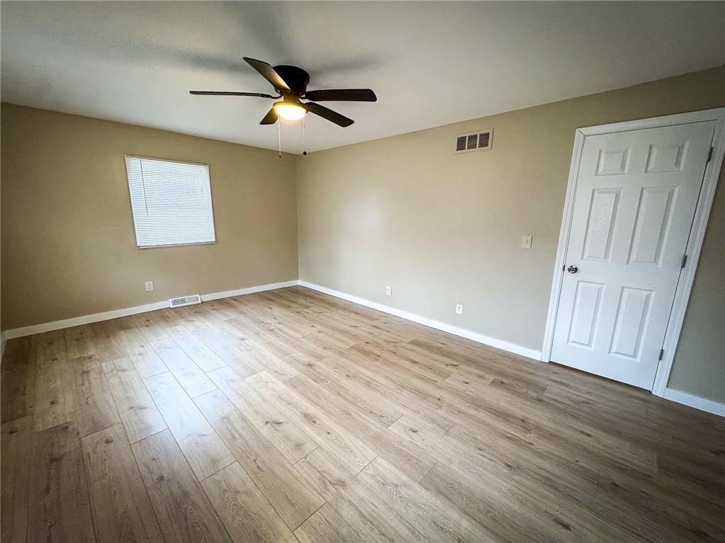 1975 Oneida Valley Road Karns City, PA 16041 - Photo 30 of 35 a view of an empty room with wooden floor and a ceiling fan