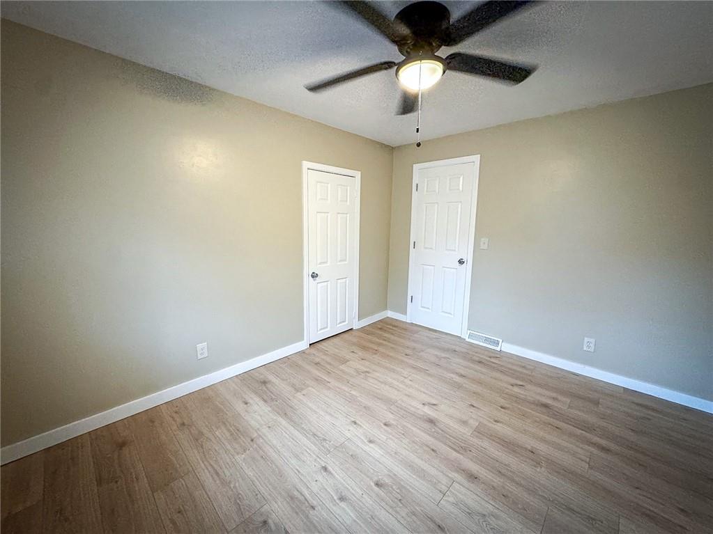 1975 Oneida Valley Road Karns City, PA 16041 - Photo 32 of 35 an empty room with wooden floor fan and windows