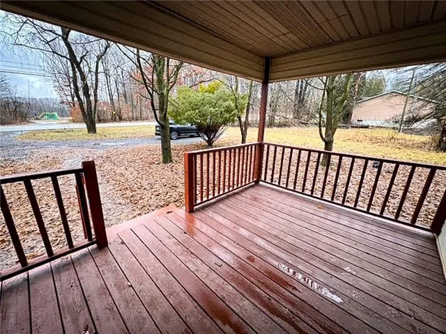 a view of wooden balcony with wooden floor