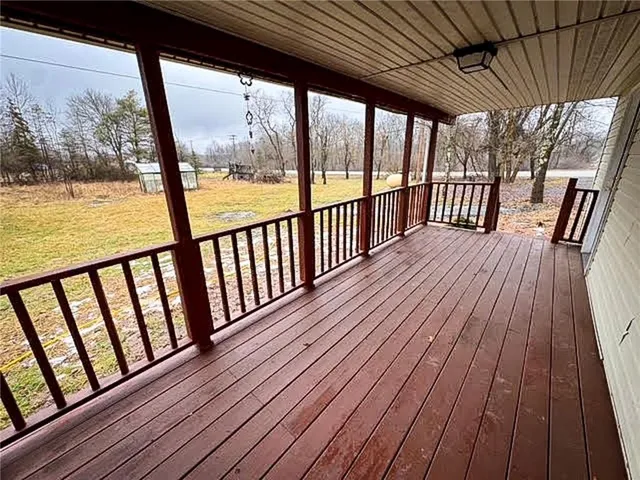 a view of wooden balcony with wooden floor