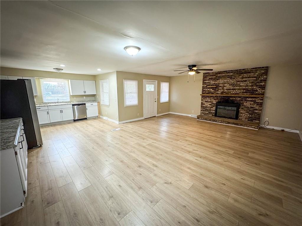 1975 Oneida Valley Road Karns City, PA 16041 - Photo 8 of 35 an empty room with wooden floor and fireplace