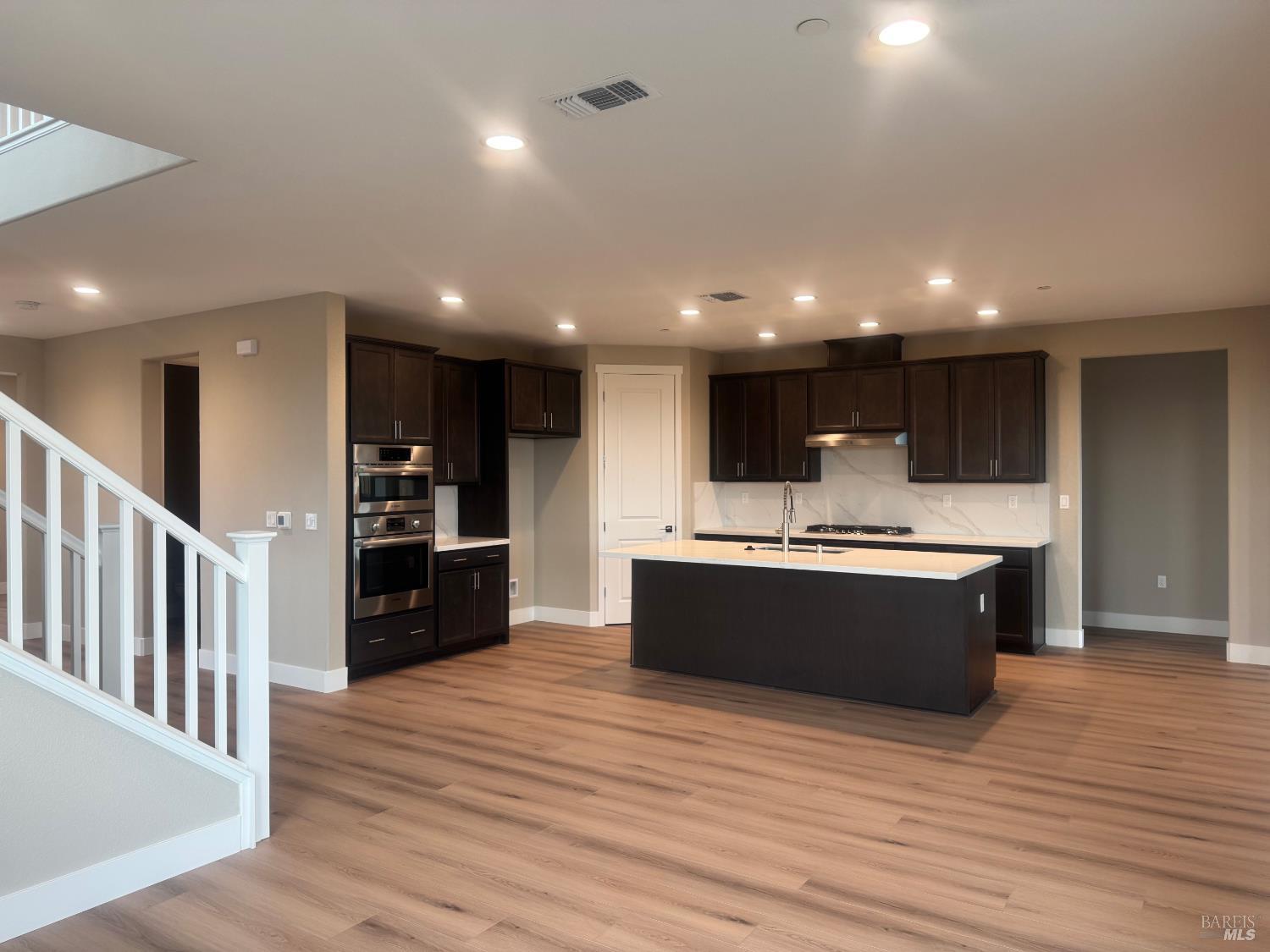 852 Baker Circle Oakley, CA 94561 - Photo 4 of 8 a large kitchen with stainless steel appliances a large counter top and wooden floors