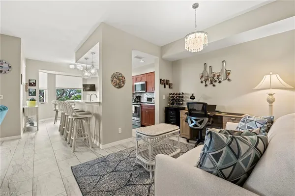 a living room with furniture dining table and a chandelier