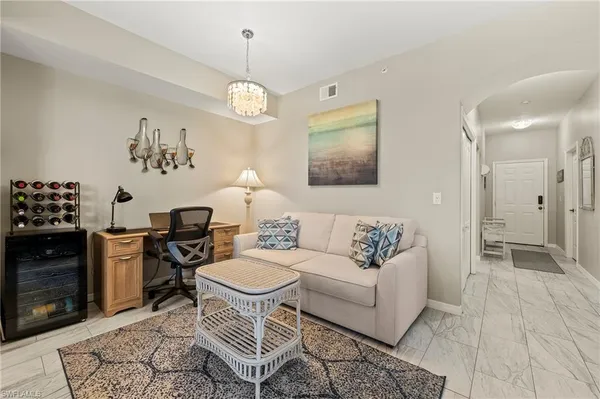 a living room with furniture a dining table and a fireplace