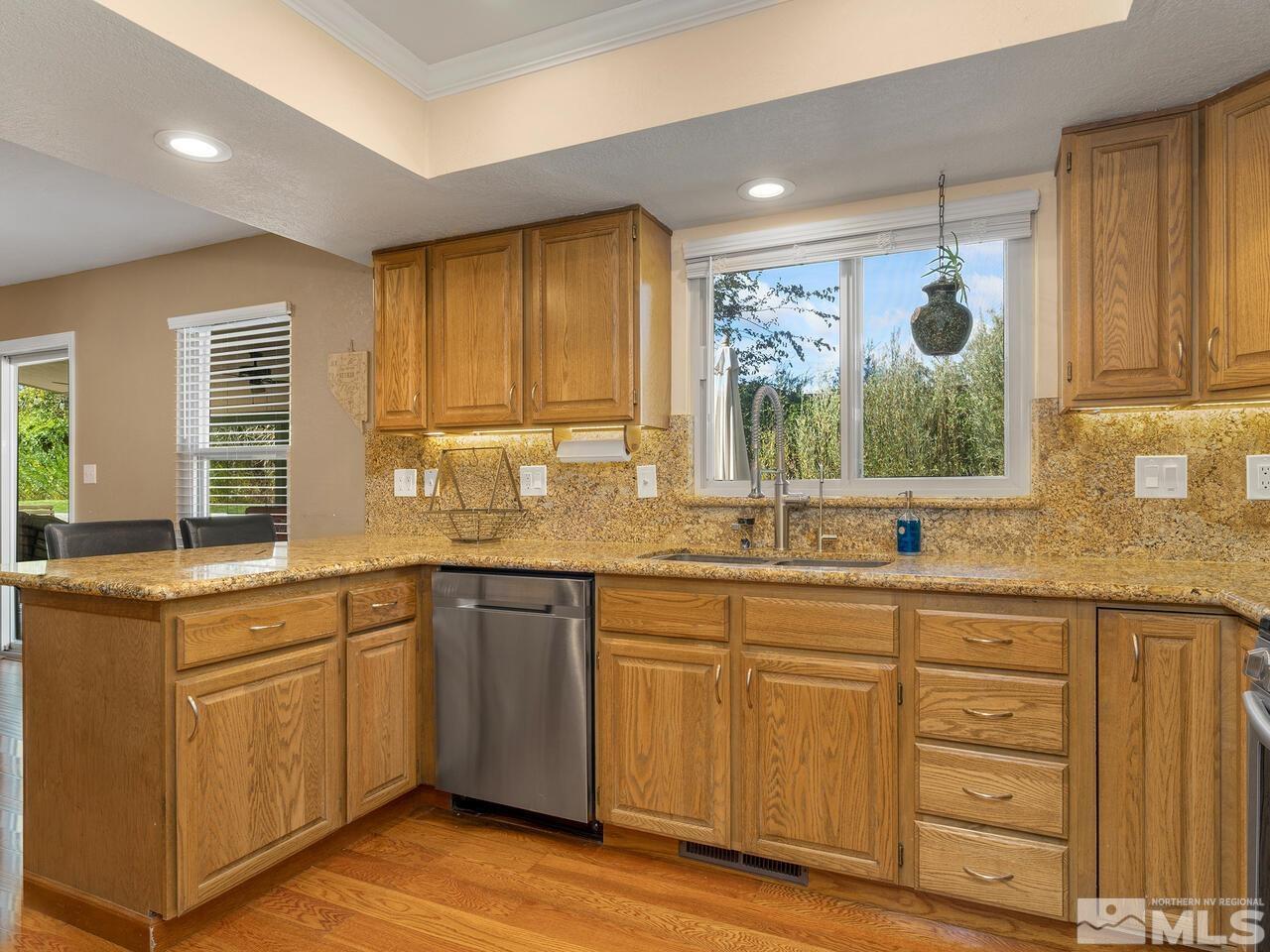 10060 Raintree Court Reno, NV 89511 - Photo 14 of 37 a kitchen with a sink cabinets and window