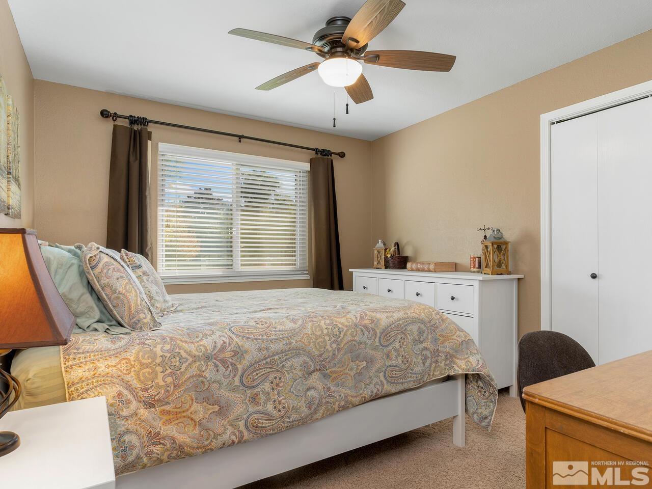 10060 Raintree Court Reno, NV 89511 - Photo 19 of 37 a bedroom with a bed dresser and a window