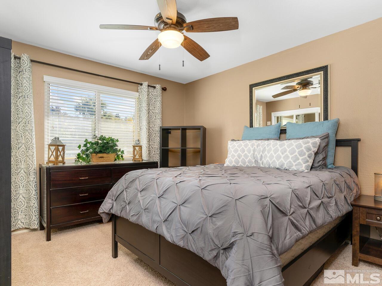 10060 Raintree Court Reno, NV 89511 - Photo 21 of 37 a bedroom with a bed and a window