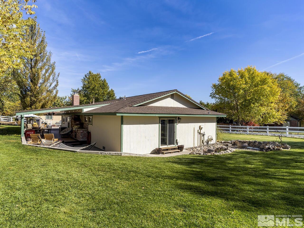 10060 Raintree Court Reno, NV 89511 - Photo 28 of 37 a front view of a house with a yard and trees