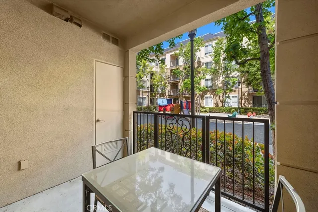 a balcony with wooden floor and outdoor seating