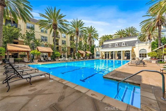 a view of a house with swimming pool and sitting area