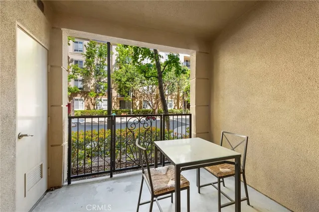 a view of a balcony dining area with furniture