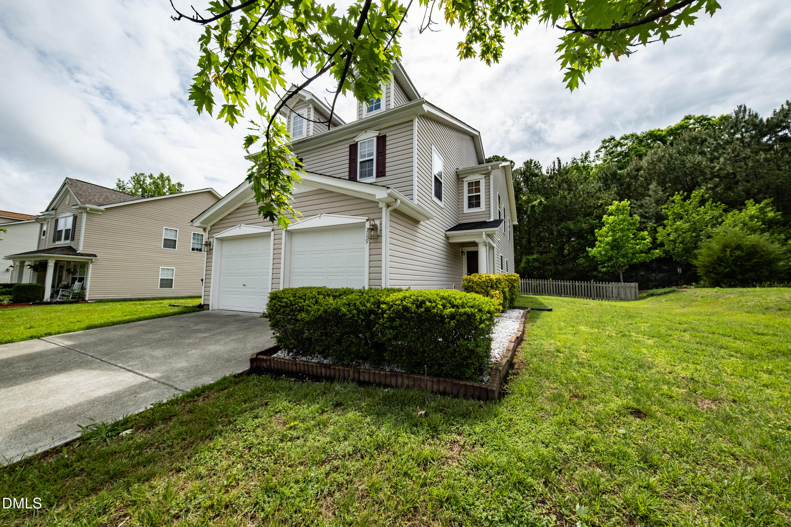719 Obsidian Way Durham, NC 27703 - Photo 2 of 41 a front view of a house with a garden