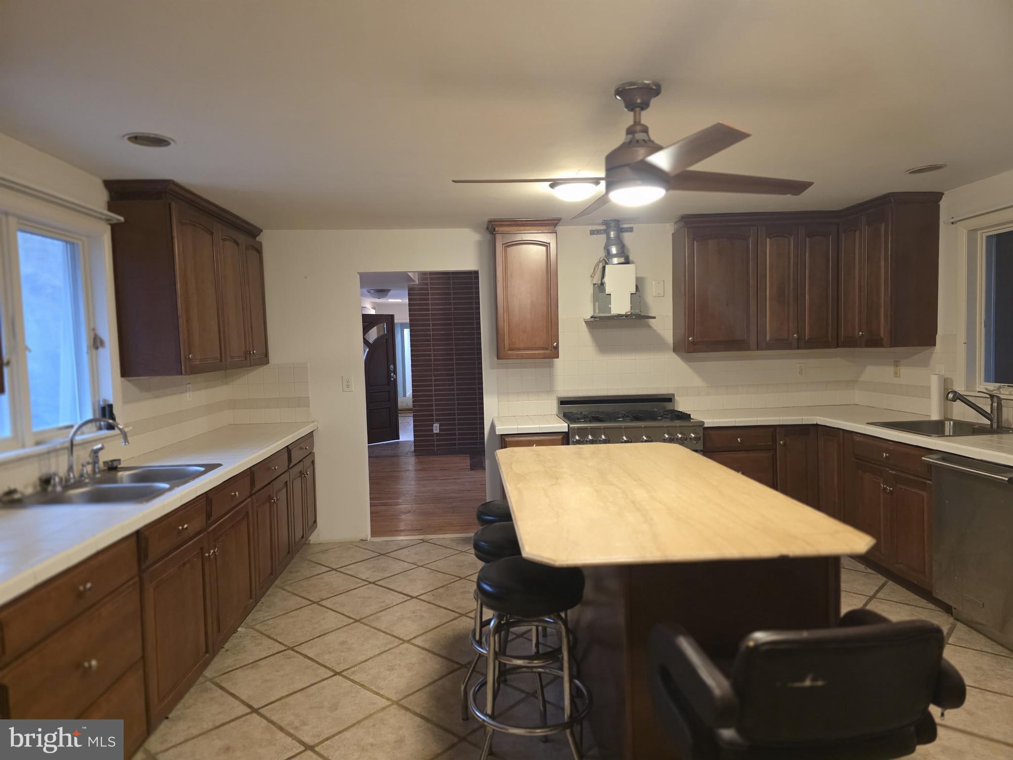 17 Cardinal Drive Moorestown, NJ 08057 - Photo 13 of 16 a kitchen with a table chairs sink and cabinets