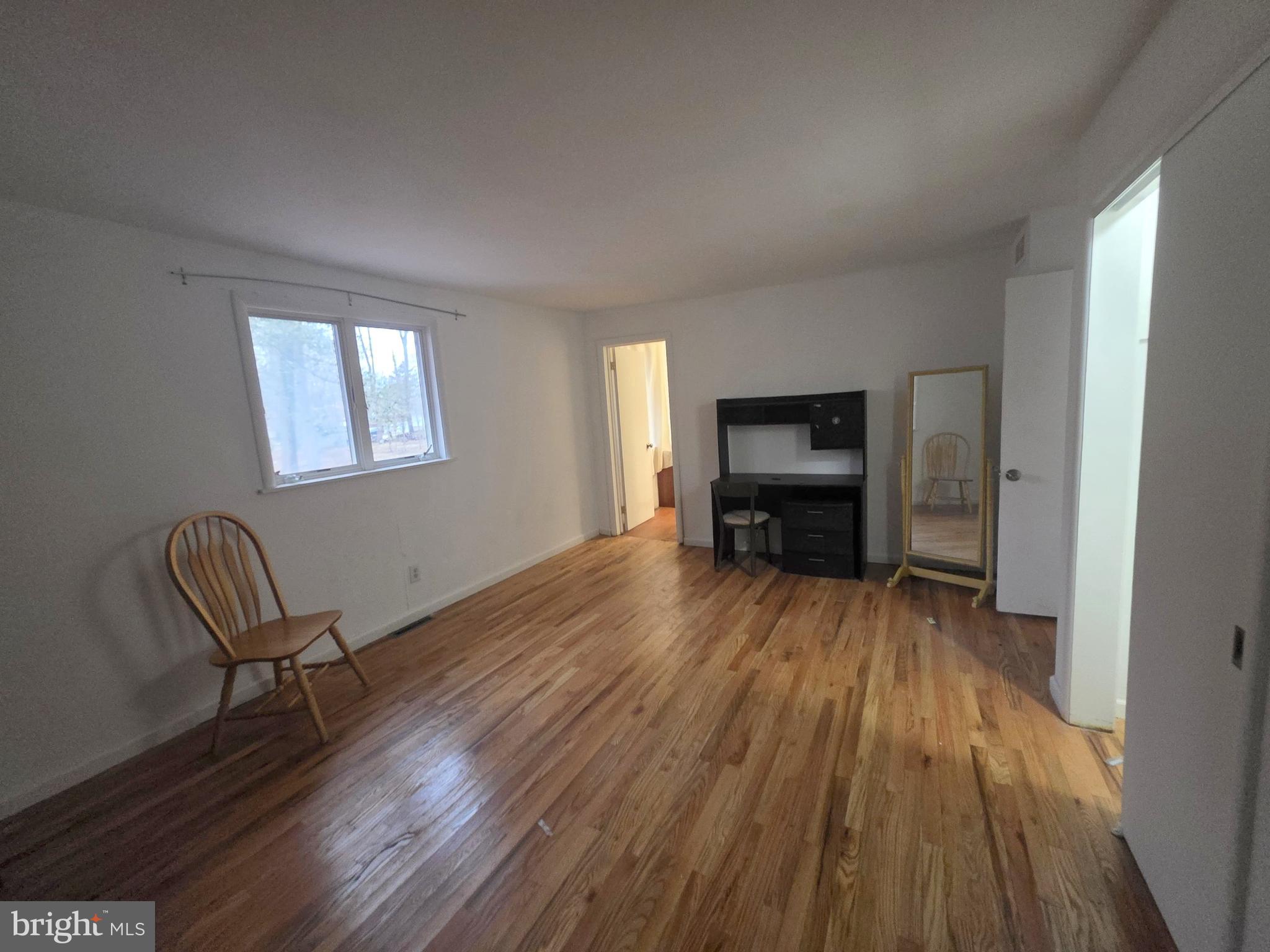17 Cardinal Drive Moorestown, NJ 08057 - Photo 15 of 16 a view of empty room with wooden floor and furniture