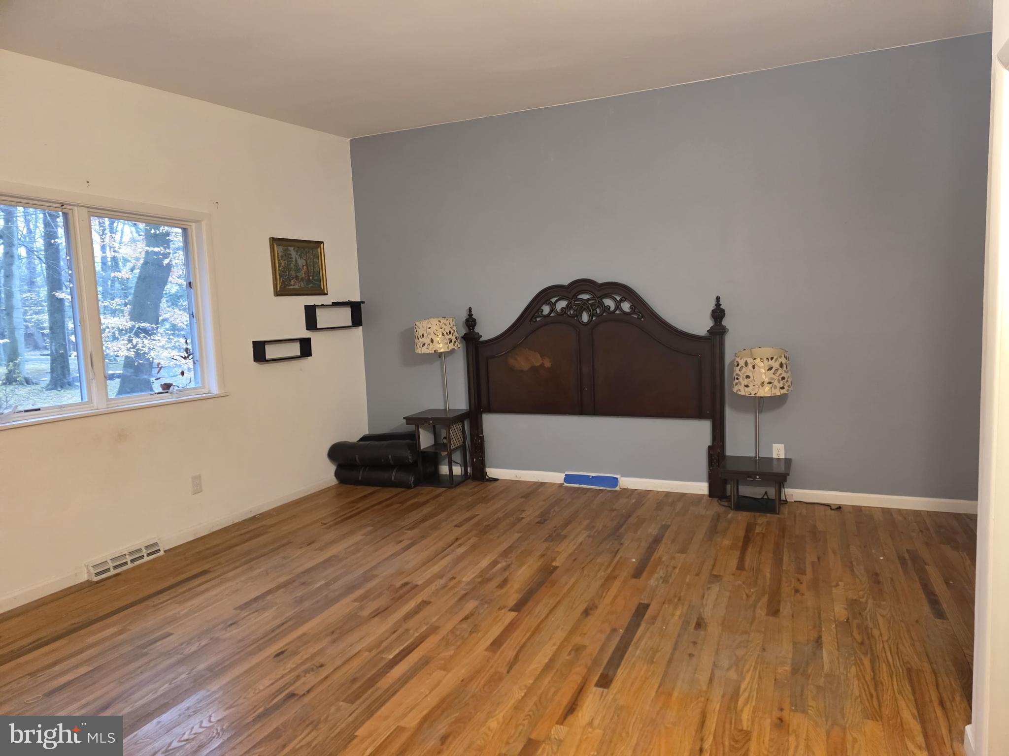17 Cardinal Drive Moorestown, NJ 08057 - Photo 7 of 16 a view of a bedroom with wooden floor and a window