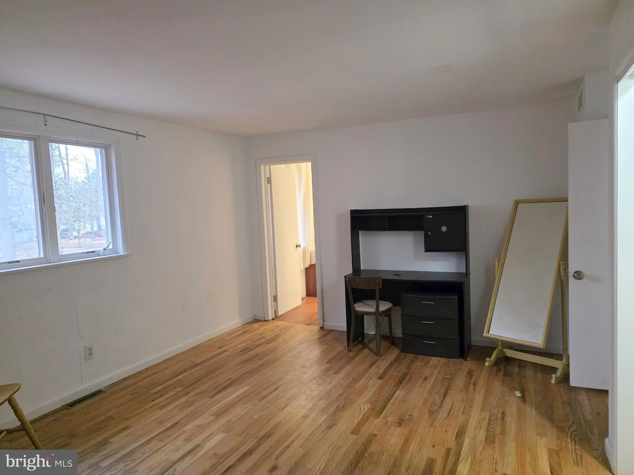 17 Cardinal Drive Moorestown, NJ 08057 - Photo 8 of 16 a view of room with window and wooden floor