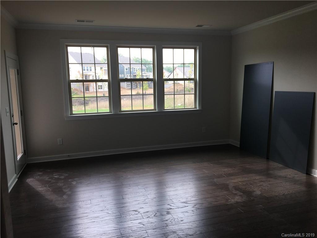 17526 Shearer Road, Unit 96 Davidson, NC 28036 - Photo 11 of 25 an empty room with wooden floor and windows