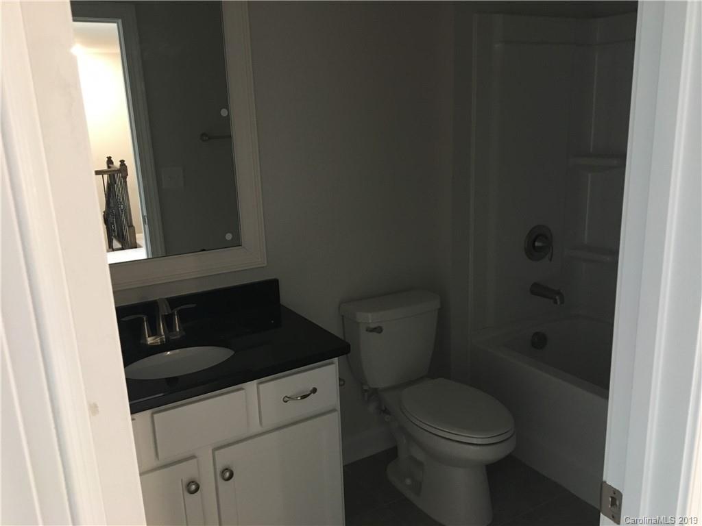 17526 Shearer Road, Unit 96 Davidson, NC 28036 - Photo 20 of 25 a bathroom with a granite countertop toilet and sink