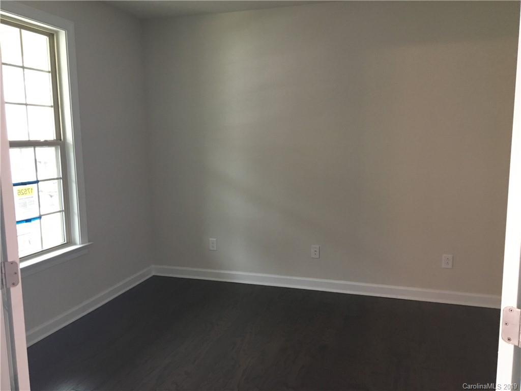17526 Shearer Road, Unit 96 Davidson, NC 28036 - Photo 4 of 25 an empty room with wooden floor and windows