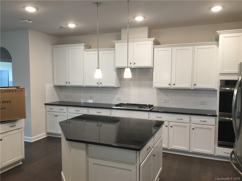 17526 Shearer Road, Unit 96 Davidson, NC 28036 - Photo 8 of 25 a kitchen with granite countertop white cabinets and white appliances