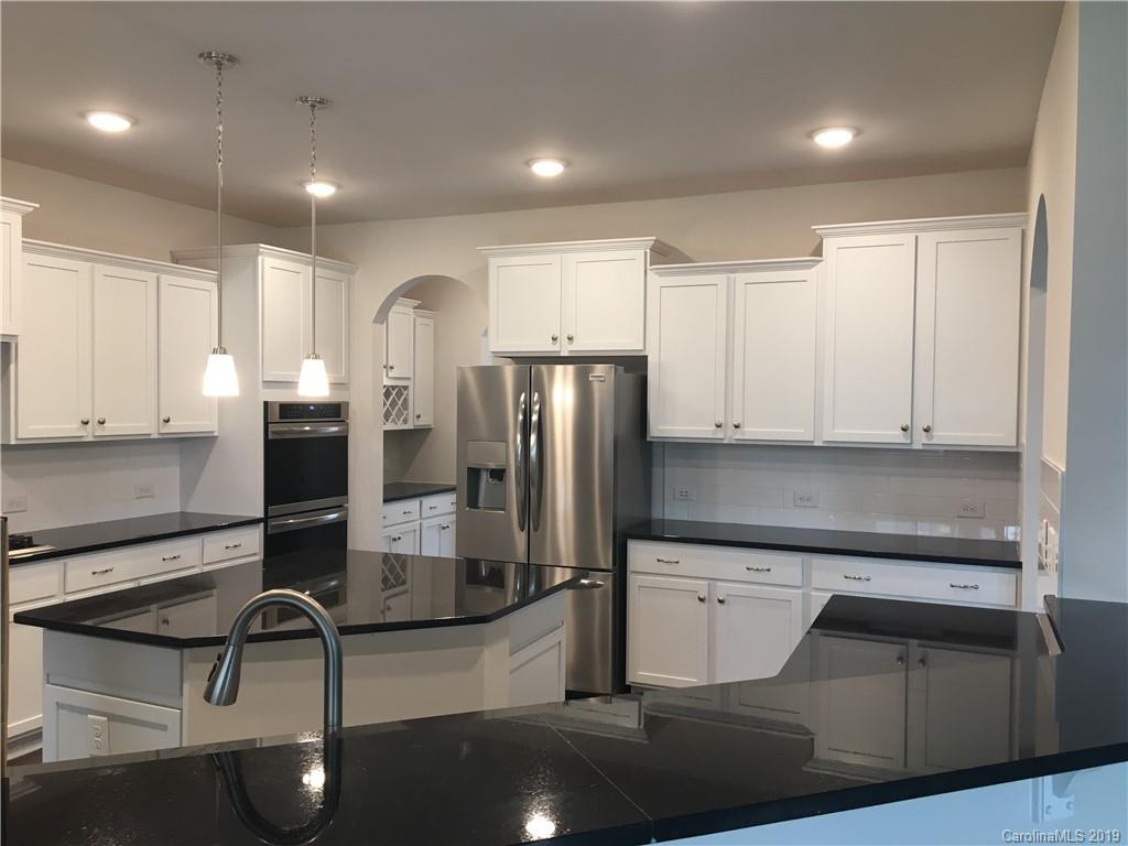 17526 Shearer Road, Unit 96 Davidson, NC 28036 - Photo 9 of 25 a kitchen with stainless steel appliances granite countertop a refrigerator and a stove