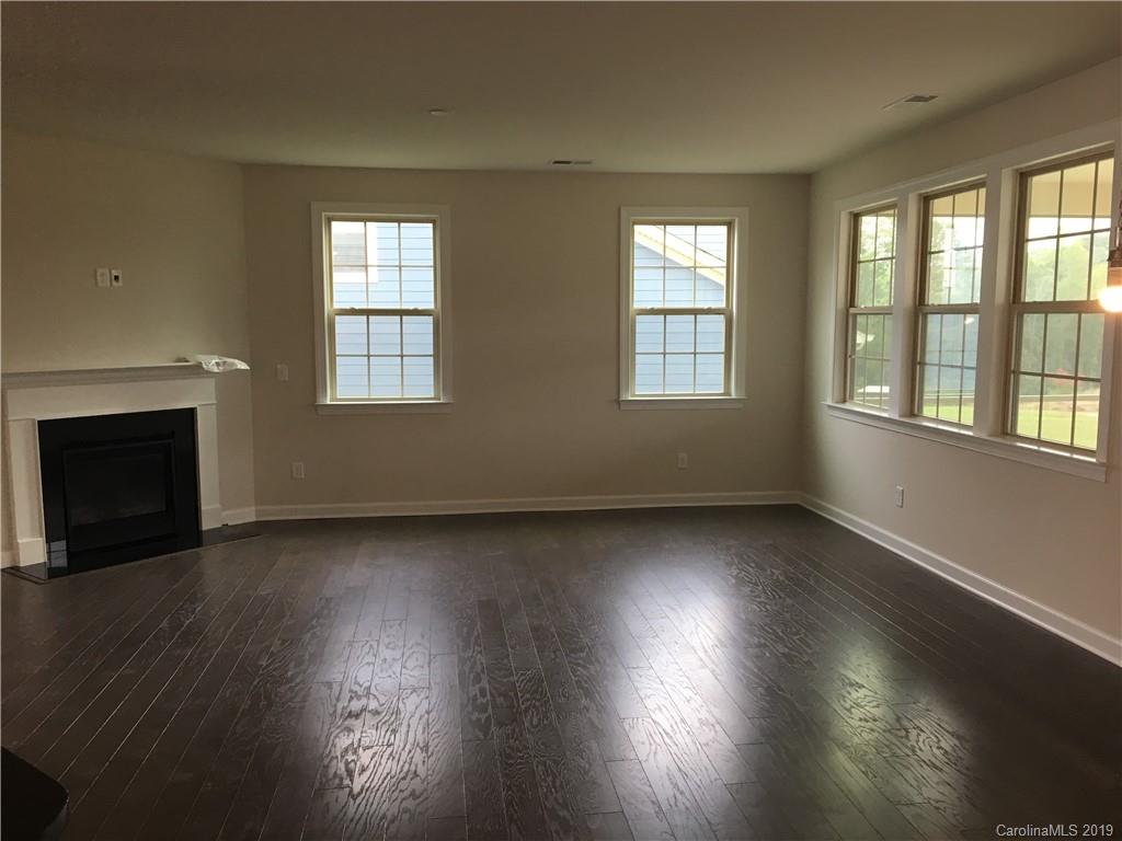 17526 Shearer Road, Unit 96 Davidson, NC 28036 - Photo 10 of 25 an empty room with wooden floor and windows