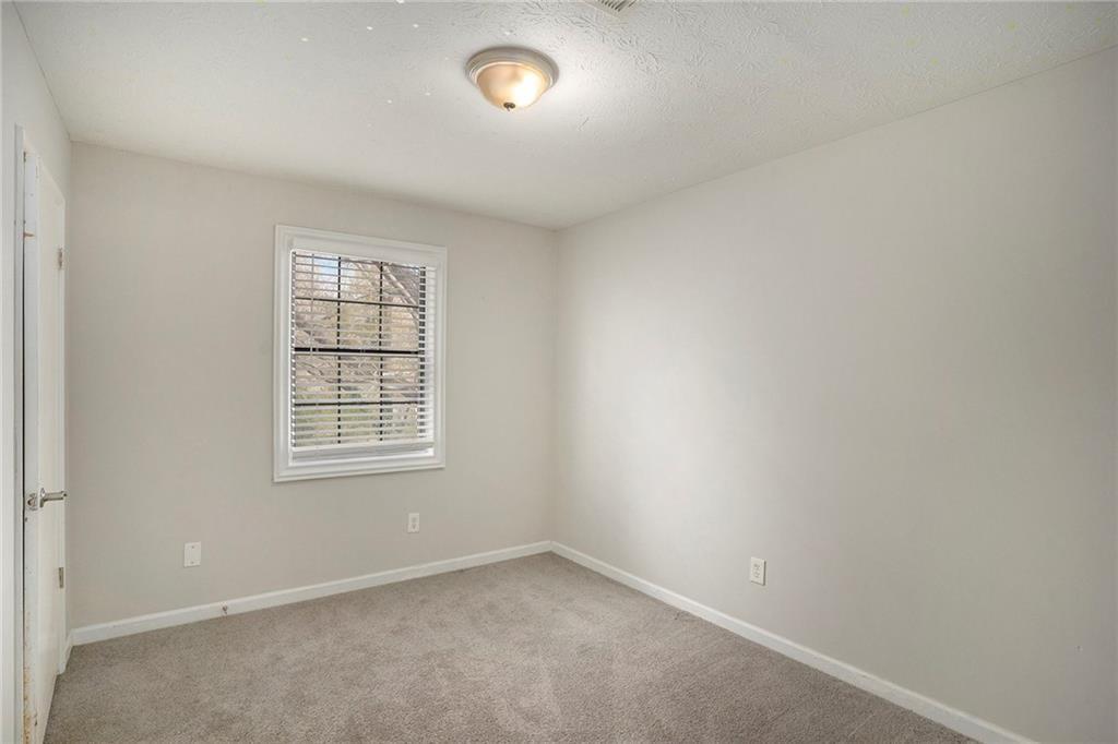 676 Tarkington Road South Stone Mountain, GA 30088 - Photo 15 of 20 an empty room with a window