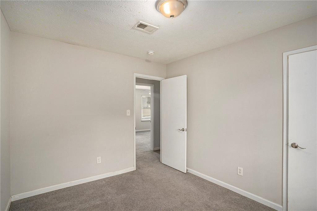 676 Tarkington Road South Stone Mountain, GA 30088 - Photo 16 of 20 wooden floor in an empty room
