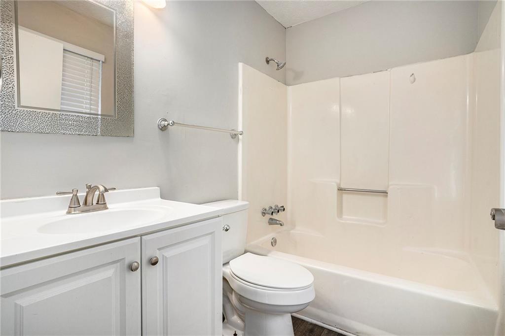 676 Tarkington Road South Stone Mountain, GA 30088 - Photo 17 of 20 a bathroom with a sink a toilet and shower