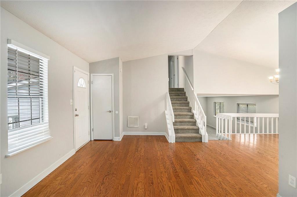 676 Tarkington Road South Stone Mountain, GA 30088 - Photo 2 of 20 a view of a livingroom with wooden floor and stairs