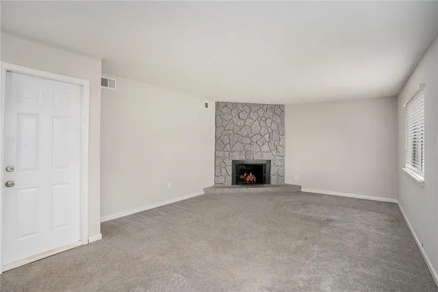 an empty room with fireplace