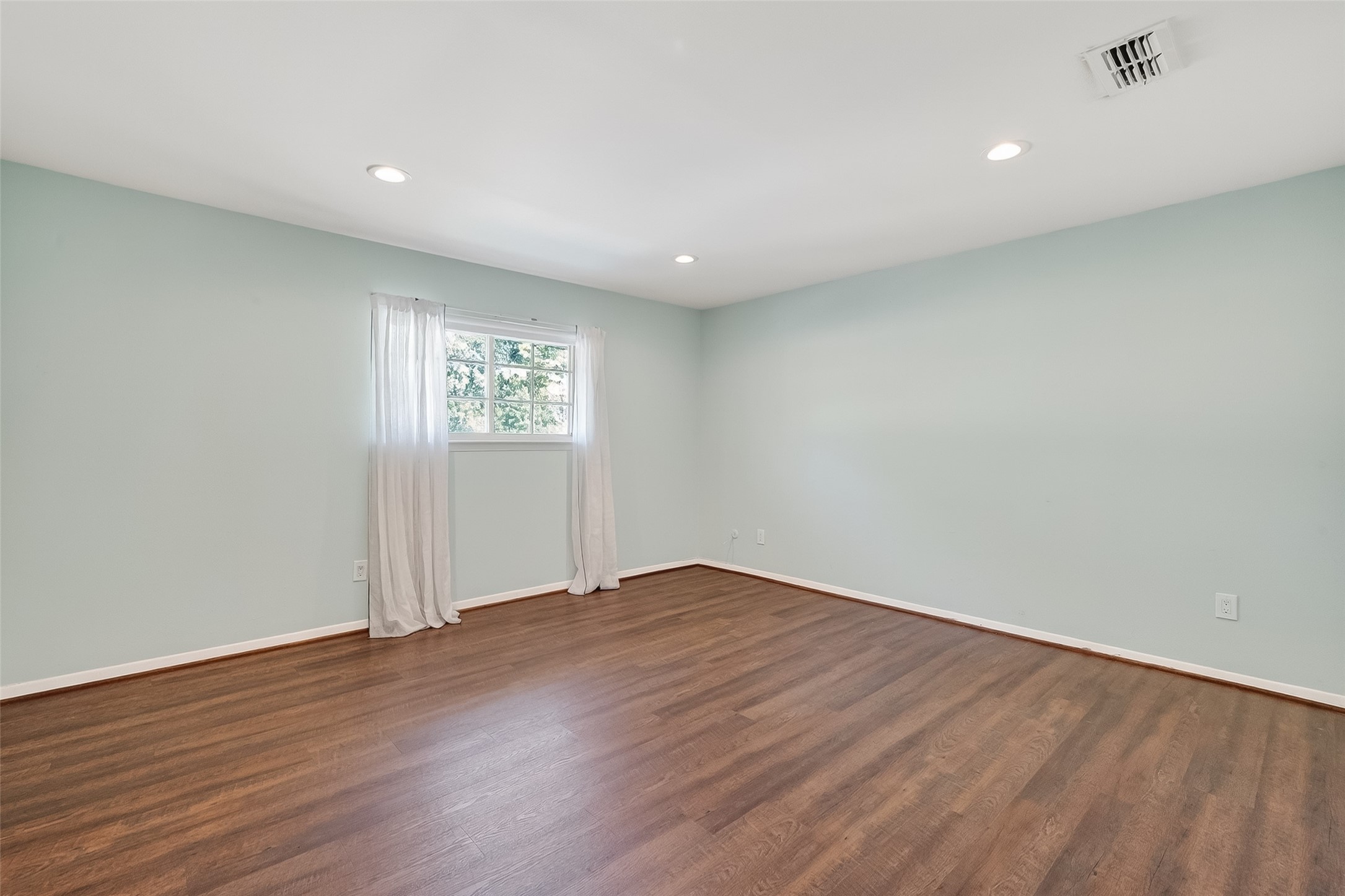 515 Tallowood Road, Unit 9 Houston, TX 77024 - Photo 12 of 18 an empty room with wooden floor and windows