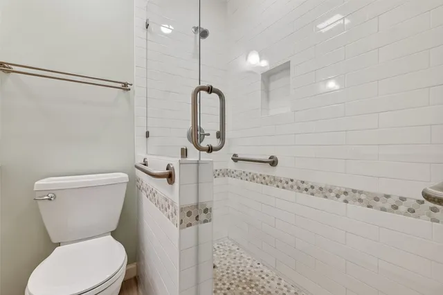 a bathroom with a toilet sink and shower