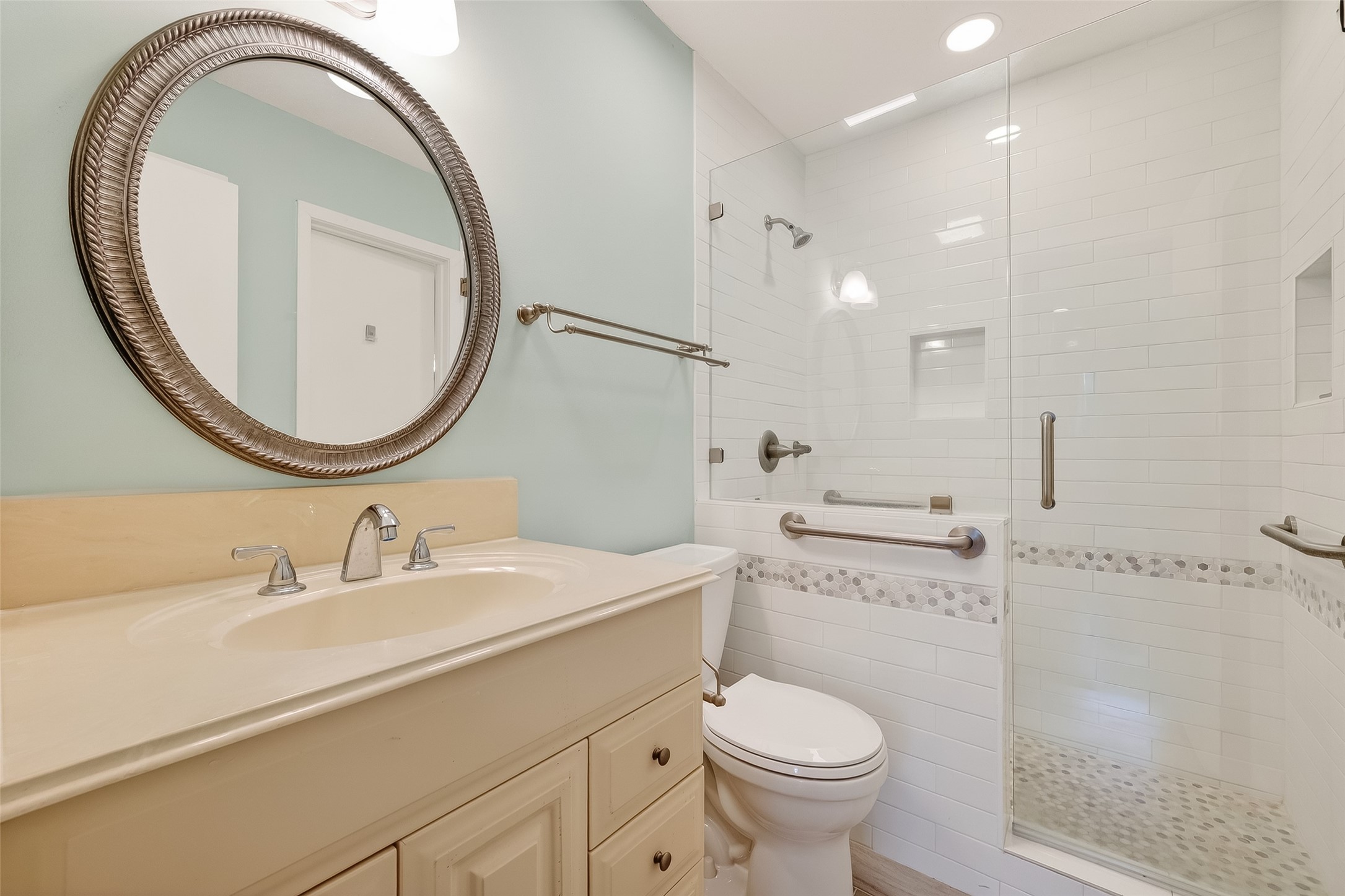 515 Tallowood Road, Unit 9 Houston, TX 77024 - Photo 15 of 18 a bathroom with a sink a toilet and a mirror