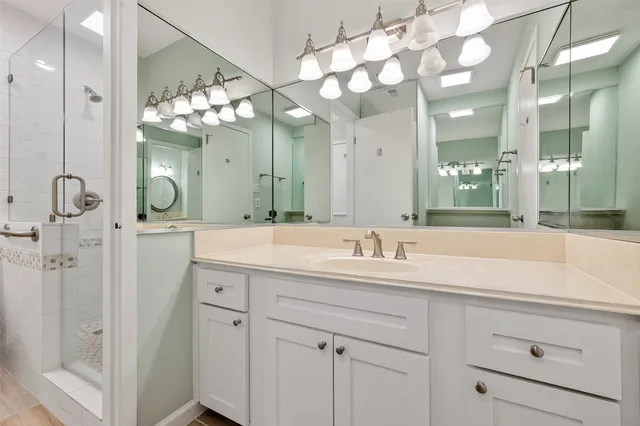 a bathroom with a sink vanity and a mirror