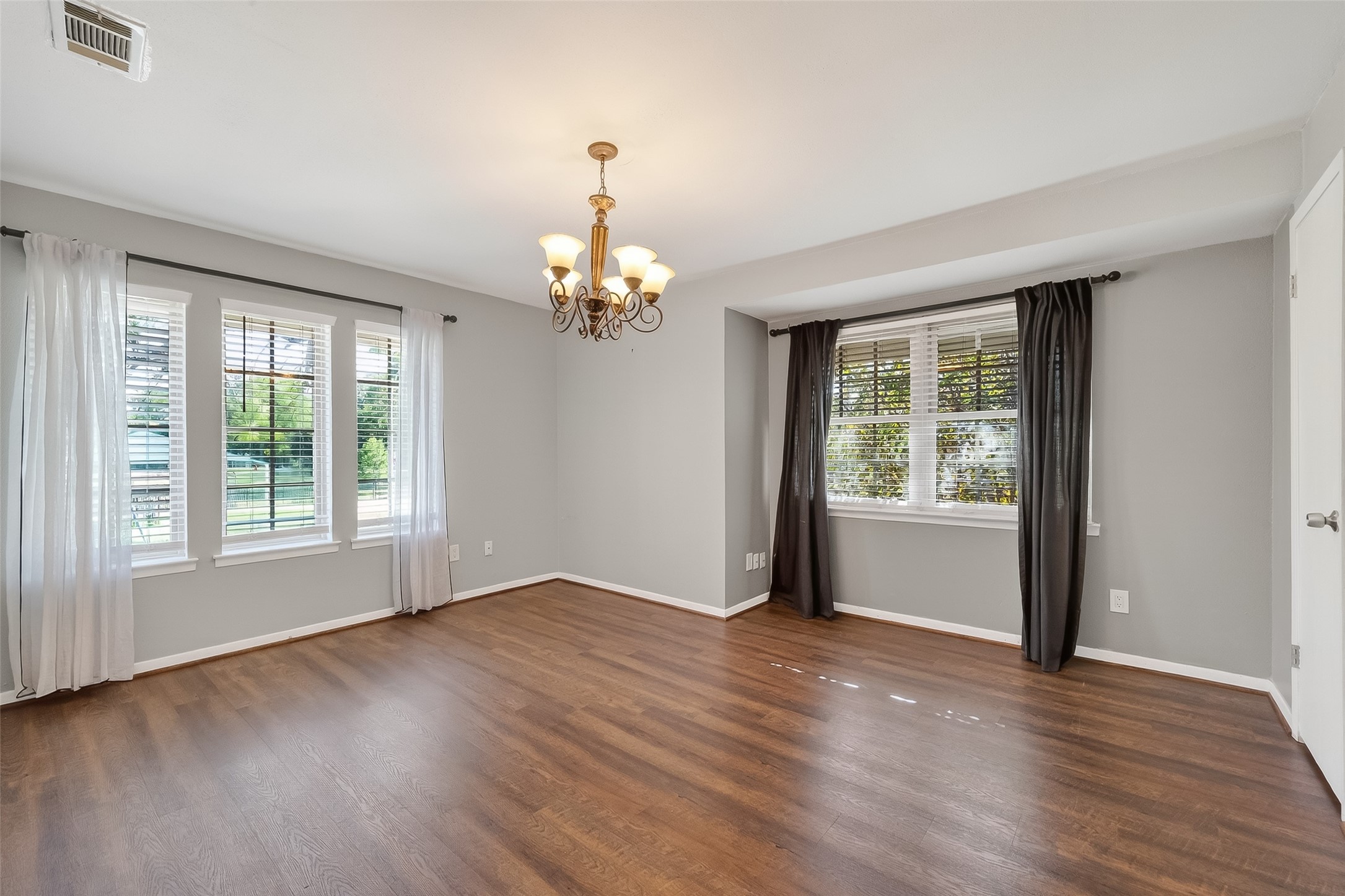 515 Tallowood Road, Unit 9 Houston, TX 77024 - Photo 4 of 18 a view of an empty room with wooden floor and a window