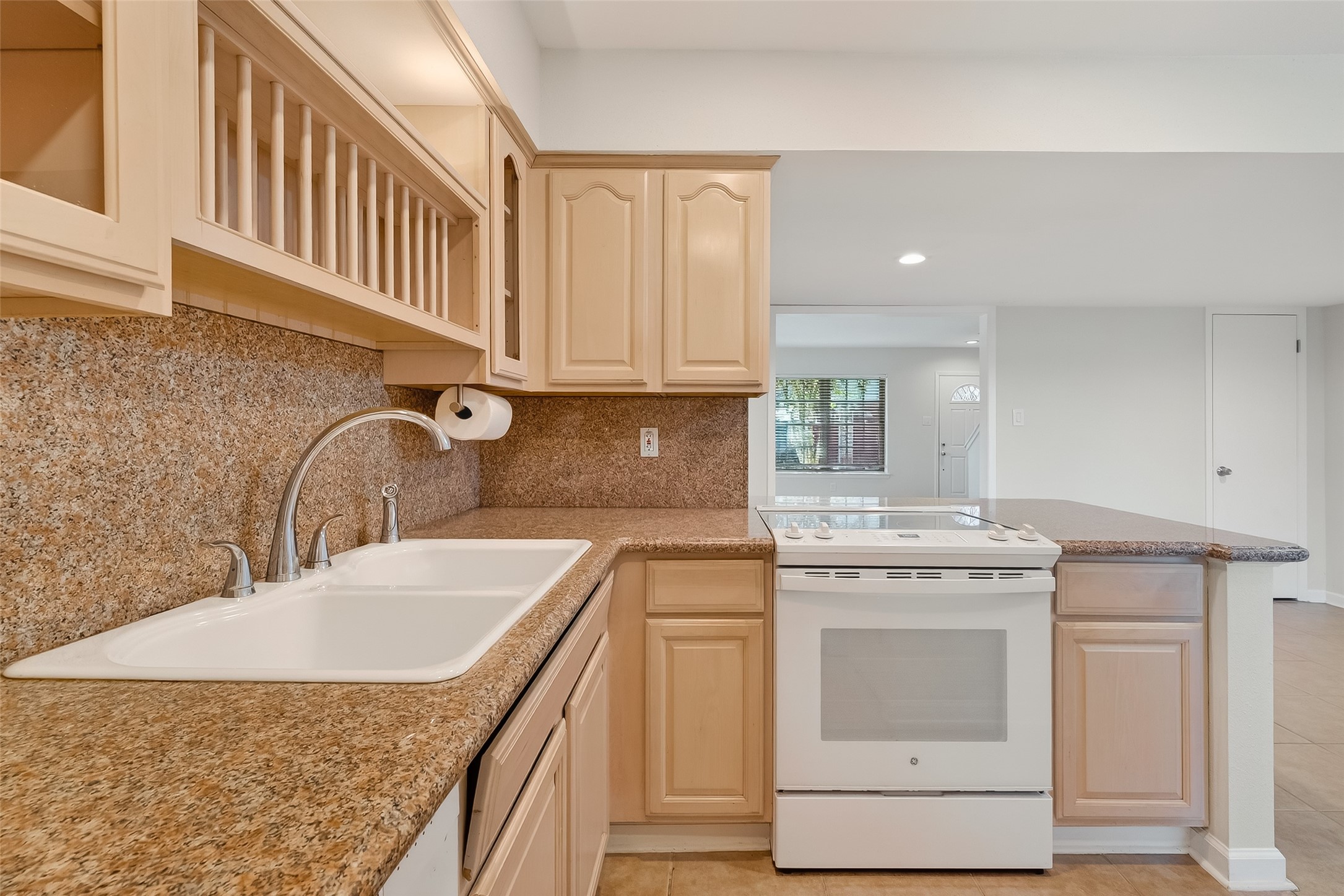515 Tallowood Road, Unit 9 Houston, TX 77024 - Photo 7 of 18 a kitchen with stainless steel appliances granite countertop a sink stove and cabinets