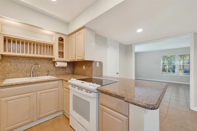 a kitchen with stainless steel appliances granite countertop a sink stove and cabinets