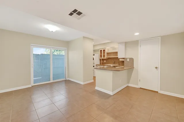 a view of kitchen with refrigerator and window