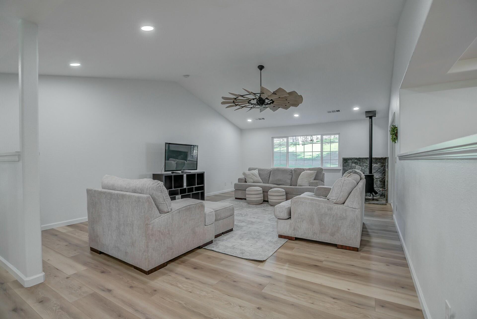 14300 Molluc Drive Red Bluff, CA 96080 - Photo 16 of 48 a living room with furniture and a chandelier