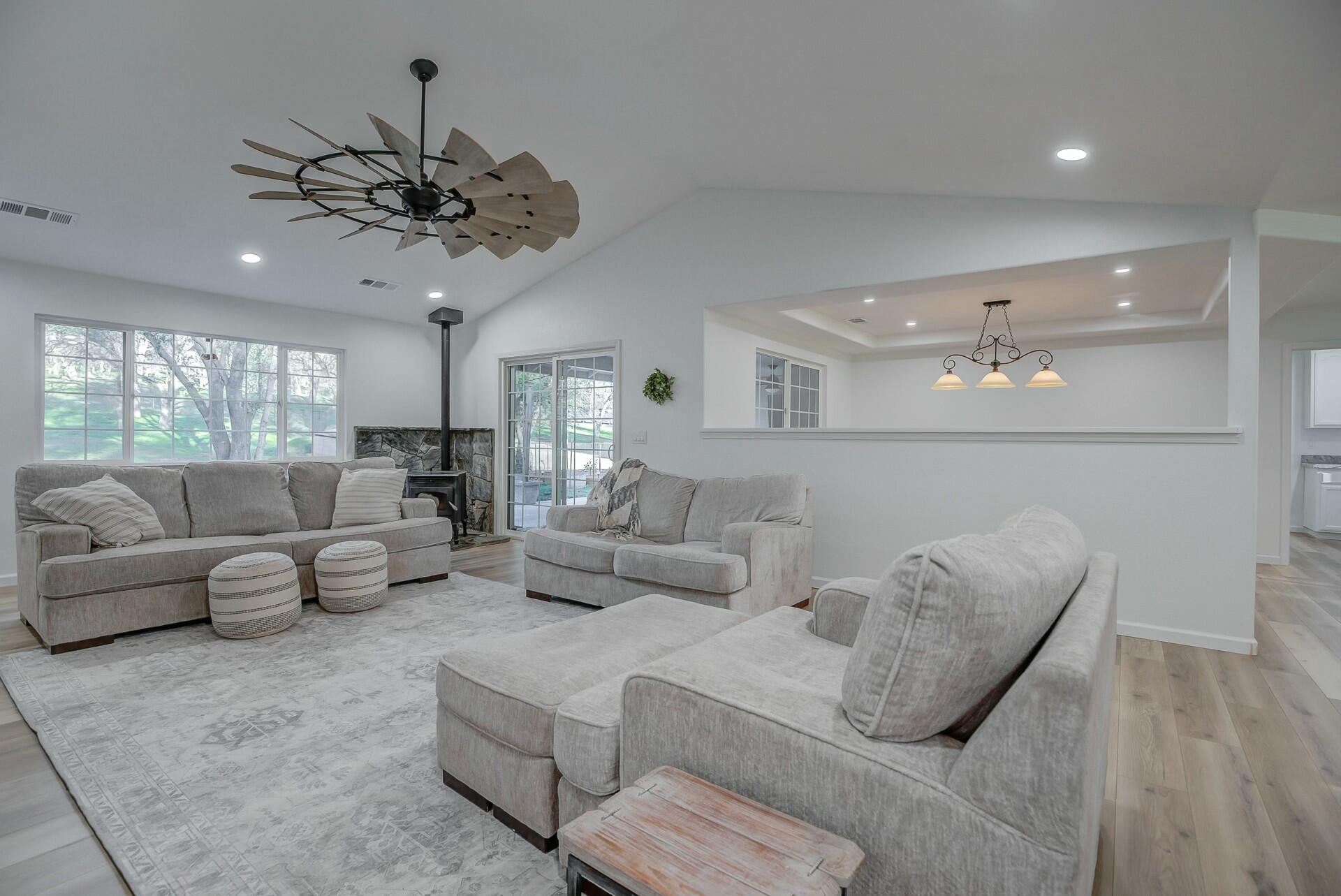 14300 Molluc Drive Red Bluff, CA 96080 - Photo 17 of 48 a living room with furniture and a chandelier