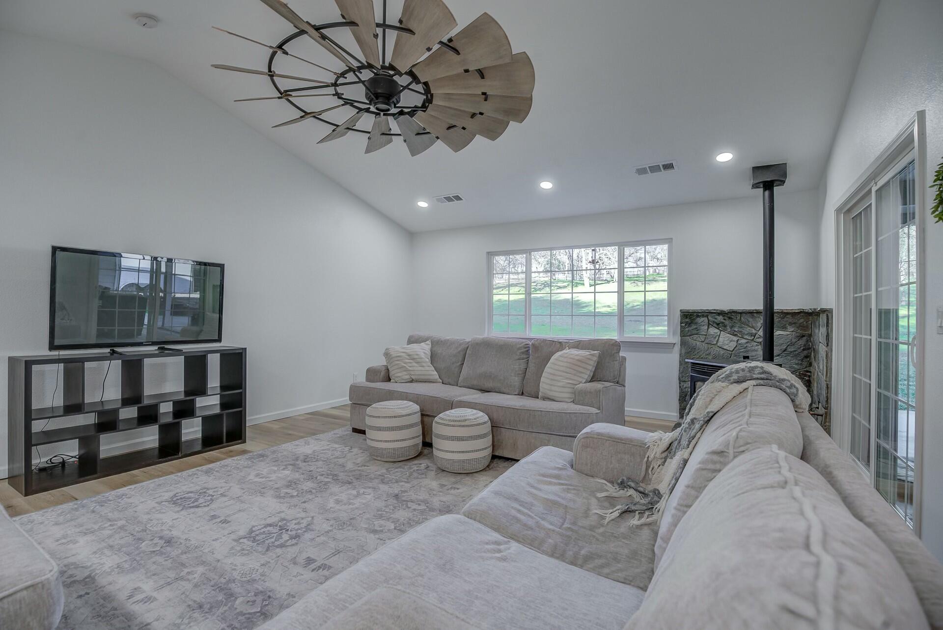 14300 Molluc Drive Red Bluff, CA 96080 - Photo 19 of 48 a living room with furniture a ceiling fan and a window