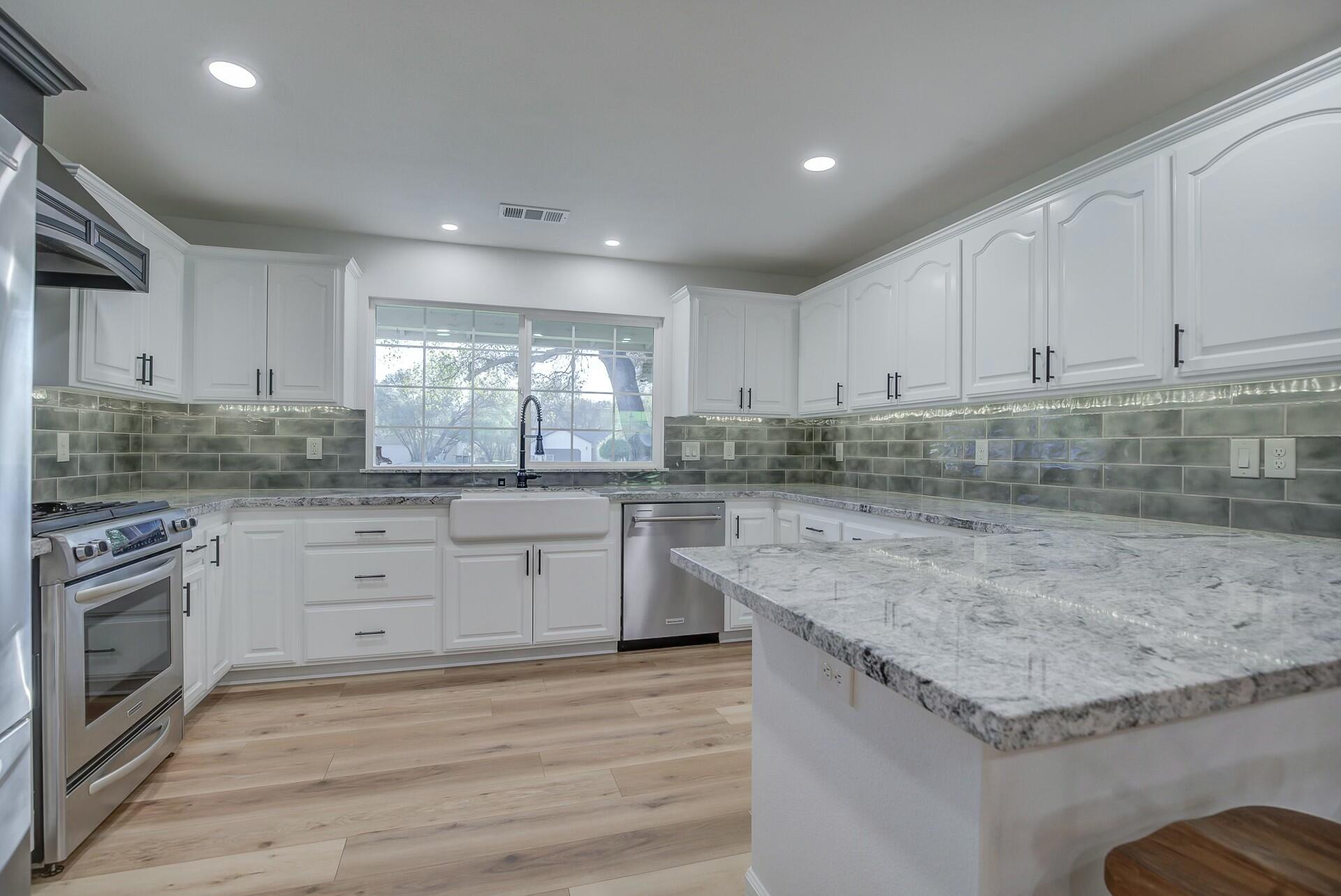 14300 Molluc Drive Red Bluff, CA 96080 - Photo 20 of 48 a kitchen with granite countertop stainless steel appliances sink and cabinets