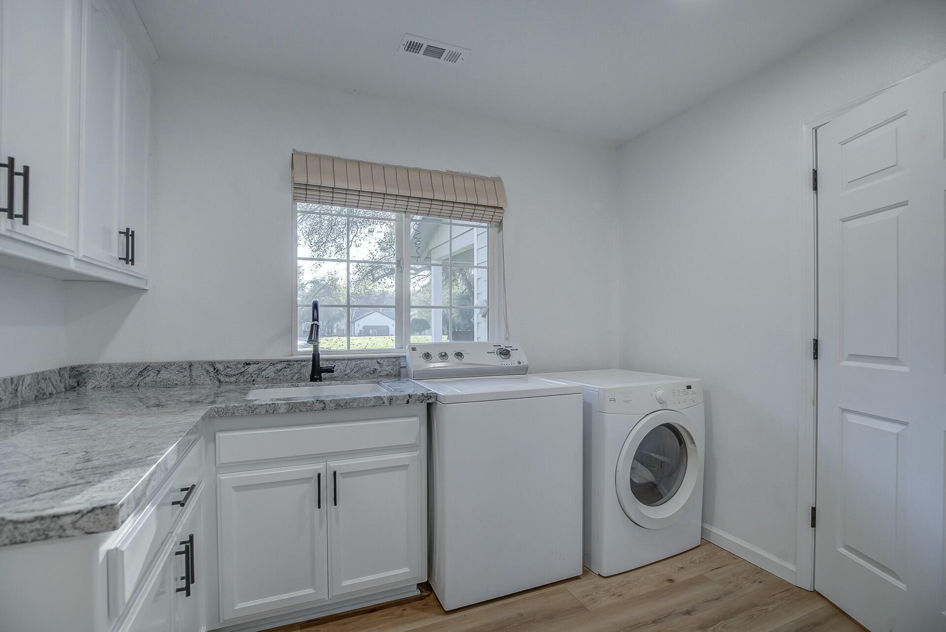 14300 Molluc Drive Red Bluff, CA 96080 - Photo 28 of 48 a kitchen with a sink a washer and dryer