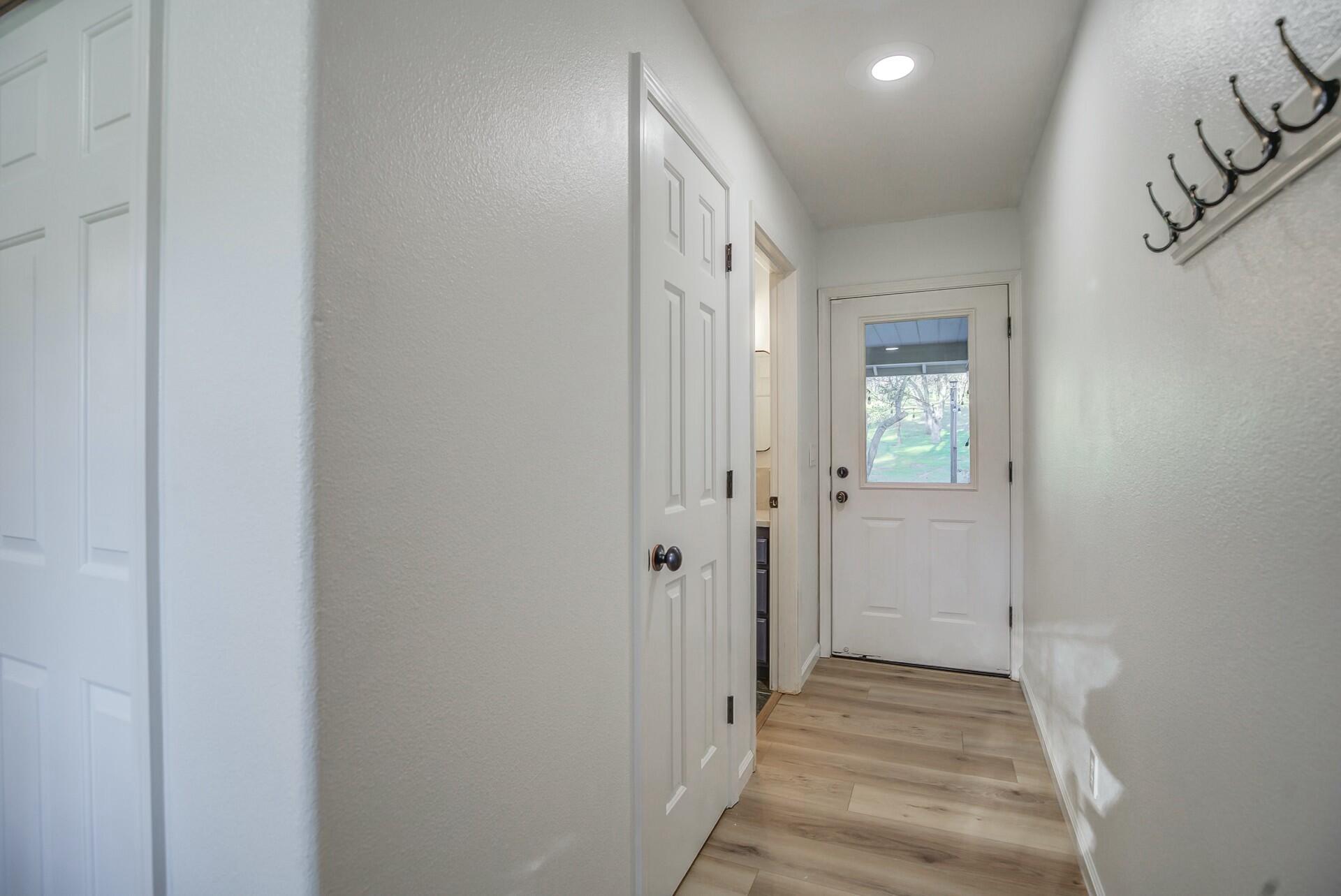 14300 Molluc Drive Red Bluff, CA 96080 - Photo 30 of 48 a view of a hallway with wooden floor and a bathroom
