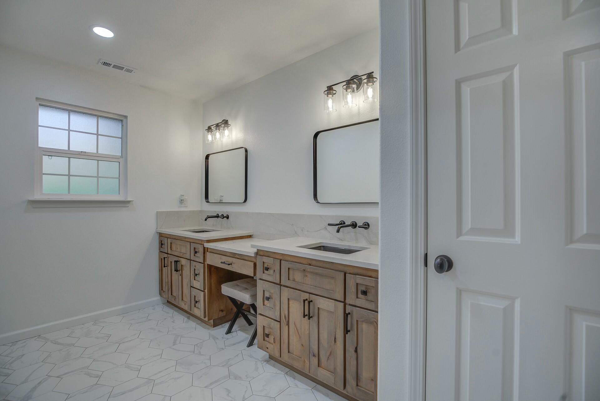 14300 Molluc Drive Red Bluff, CA 96080 - Photo 42 of 48 a spacious bathroom with a double vanity sink and a mirror