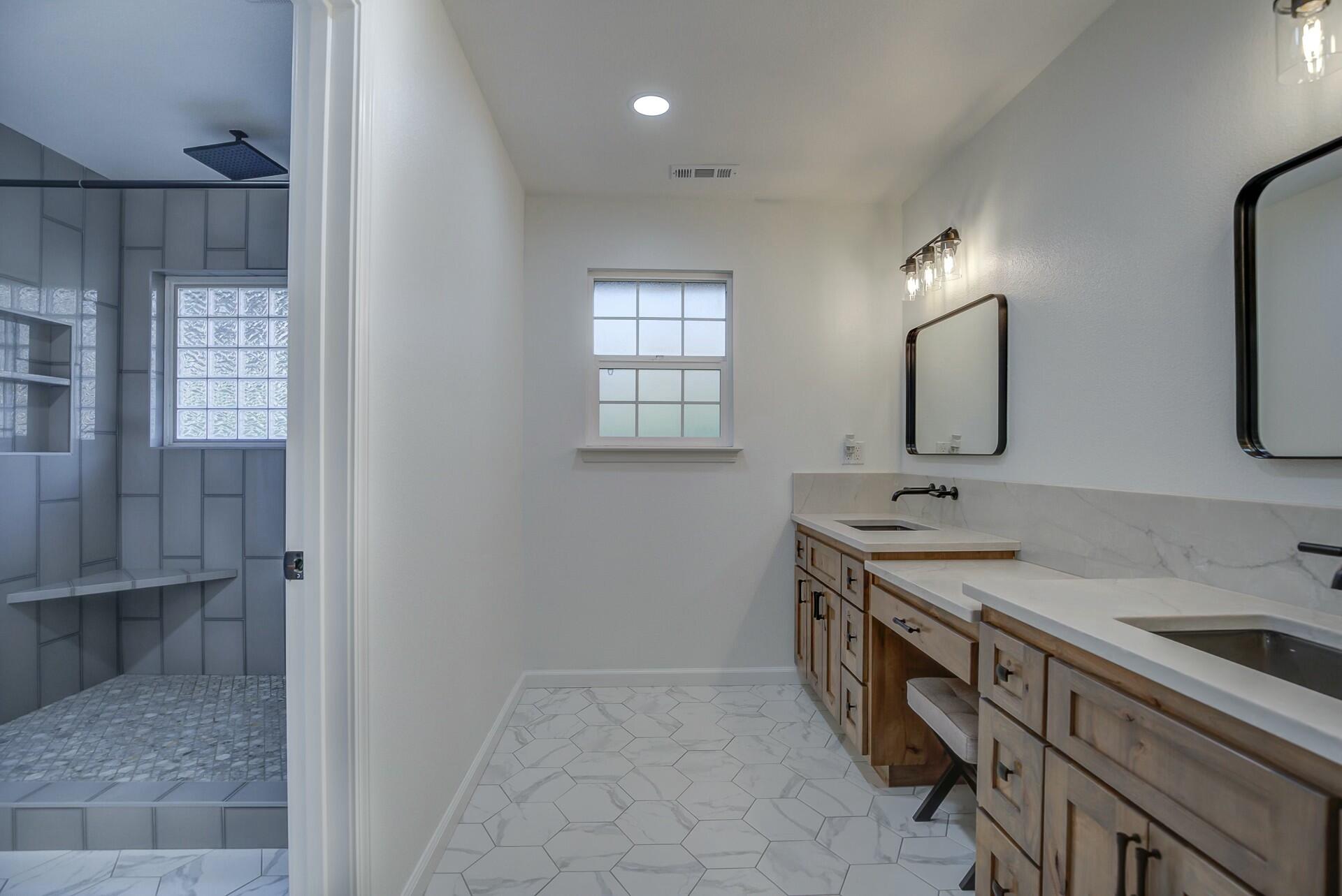 14300 Molluc Drive Red Bluff, CA 96080 - Photo 43 of 48 a spacious bathroom with a double vanity sink a mirror and a shower