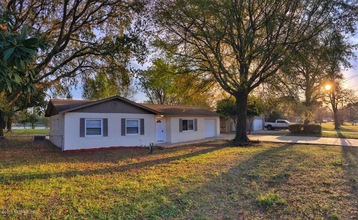 a view of a house with a yard covered in snow