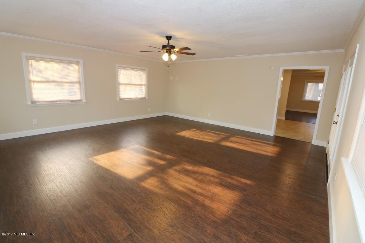 8584 Old Plank Road Jacksonville, FL 32220 - Photo 13 of 23 a view of an empty room with wooden floor and a window