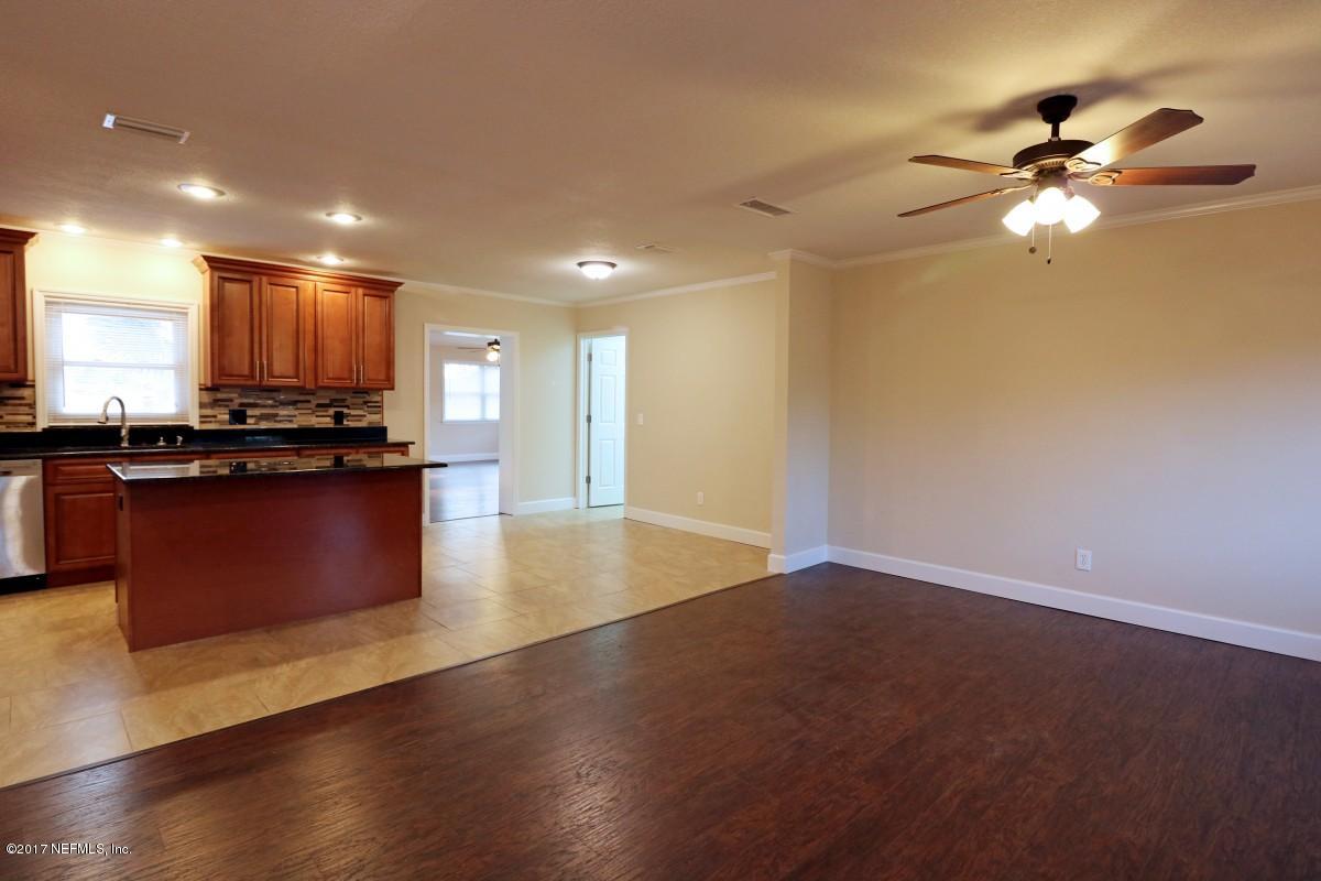 8584 Old Plank Road Jacksonville, FL 32220 - Photo 15 of 23 a view of kitchen with refrigerator stove and wooden cabinets